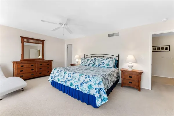 a bedroom with two beds and painting on the wall