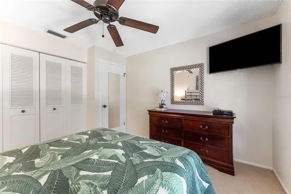 a bedroom with a bed and a flat screen tv