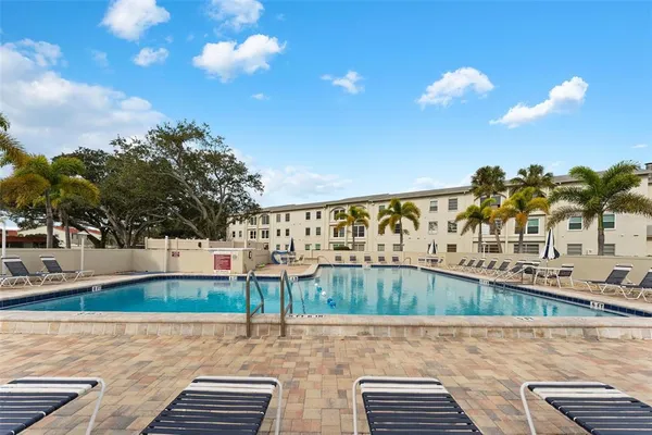 a view of swimming pool with outdoor seating and city view