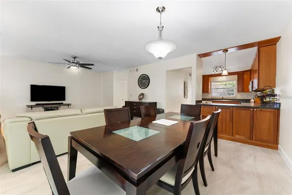 a view of a dining room with furniture and a flat screen tv