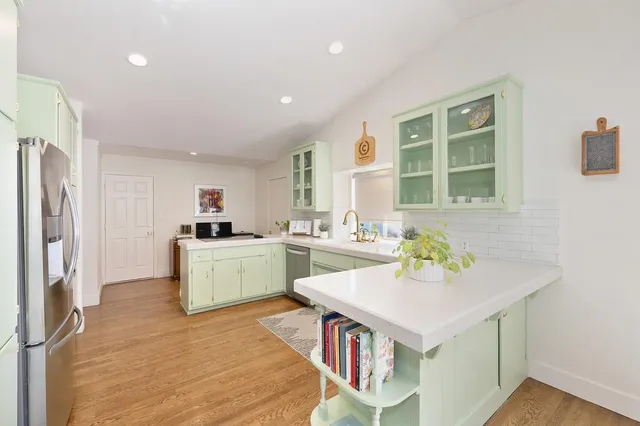 a kitchen that has a sink and chair in it