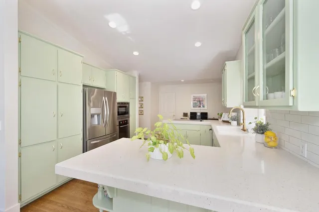 a kitchen with stainless steel appliances a refrigerator sink and cabinets