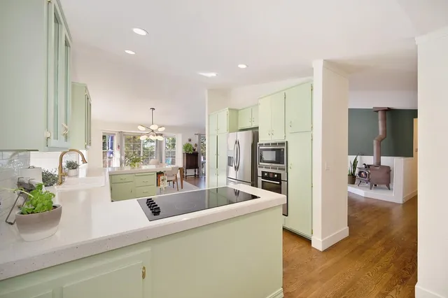 a kitchen with stainless steel appliances a refrigerator sink and microwave