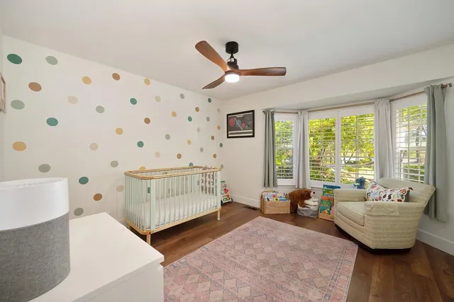 a bedroom with a large bed and a large window