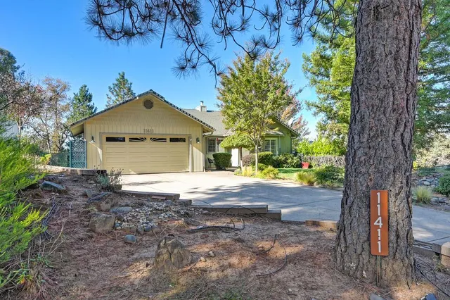 a view of a house with a tree in front
