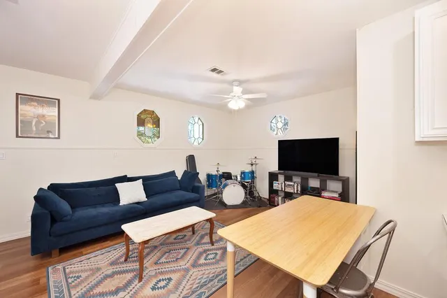 a view of a patio with table and chairs under an umbrella