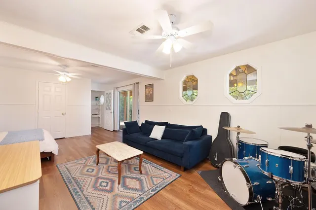 a view of a patio with table and chairs under an umbrella