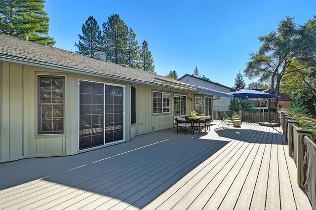 an aerial view of residential house with green space and trees all around