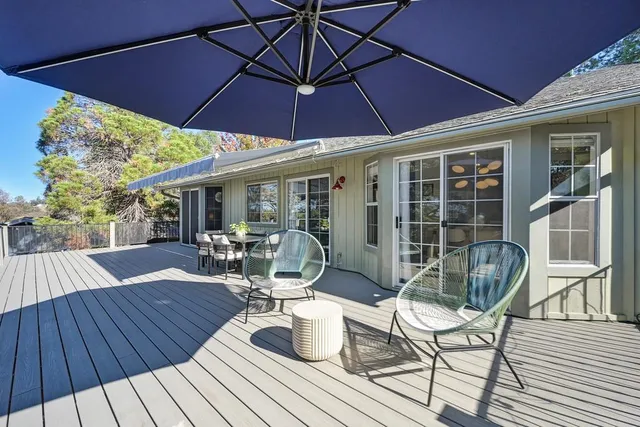 a view of a house with a swimming pool and sitting area