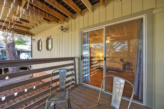 an aerial view of a house with outdoor space and a lake view in back