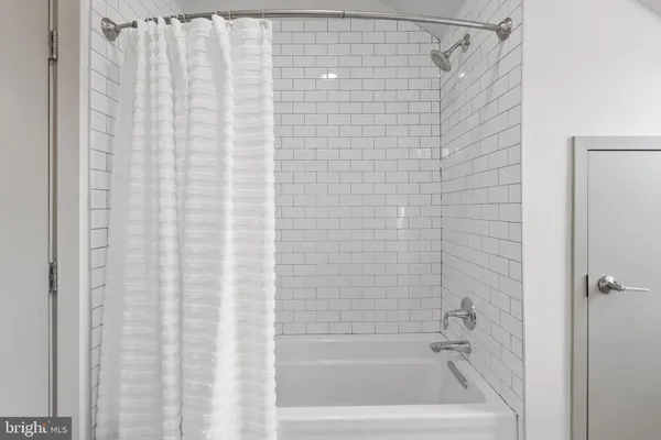 a bathroom with a granite countertop toilet sink and mirror