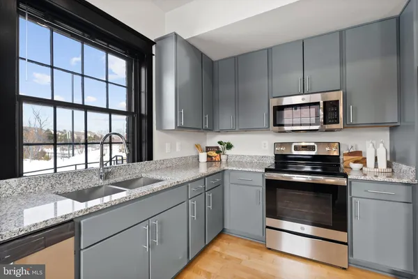 a kitchen with granite countertop a stove and a sink