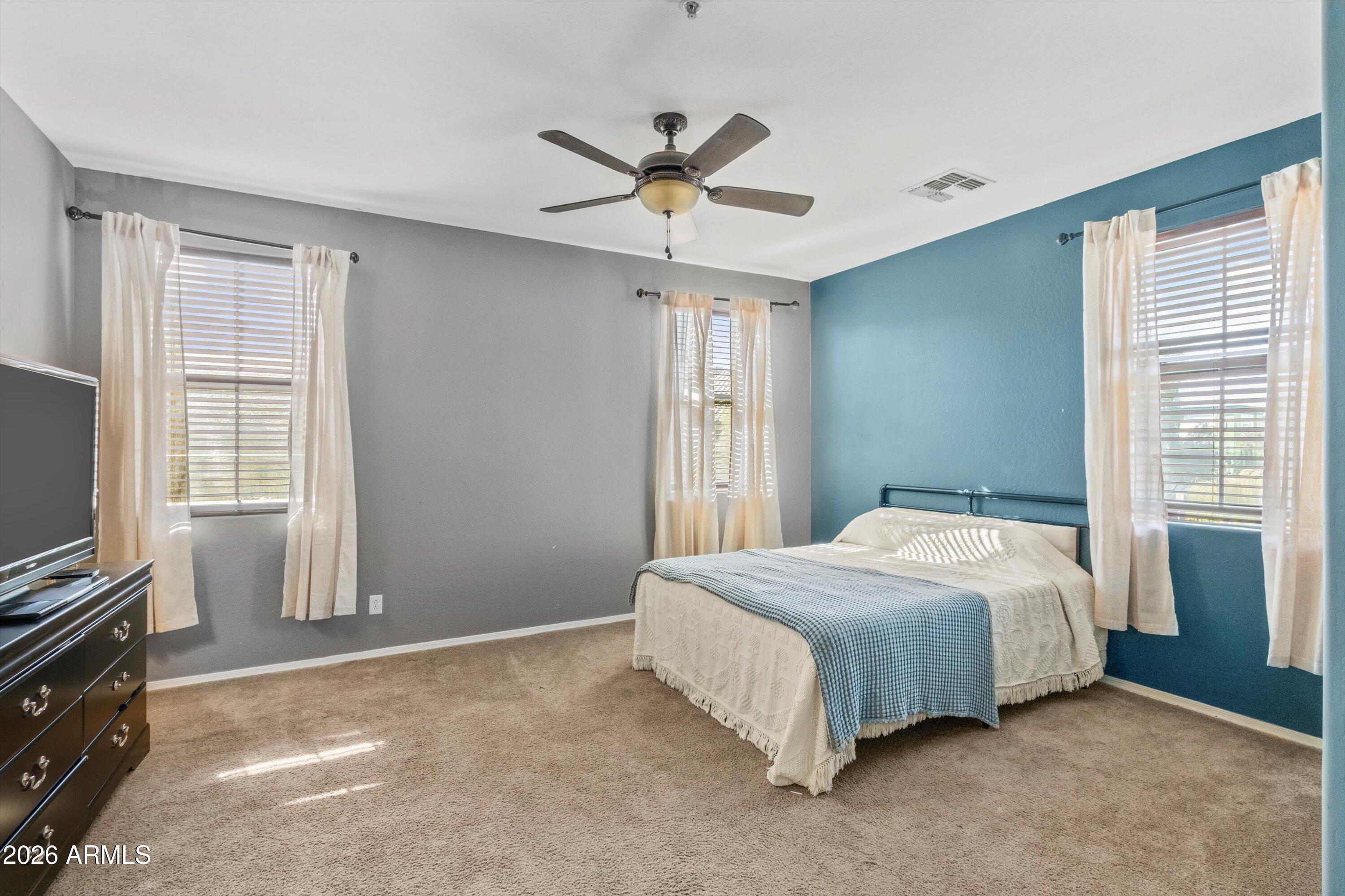 1250 South Rialto, Unit 11 Mesa, AZ 85209 - Photo 14 of 21 a bedroom with a bed and a flat tv screen on dresser