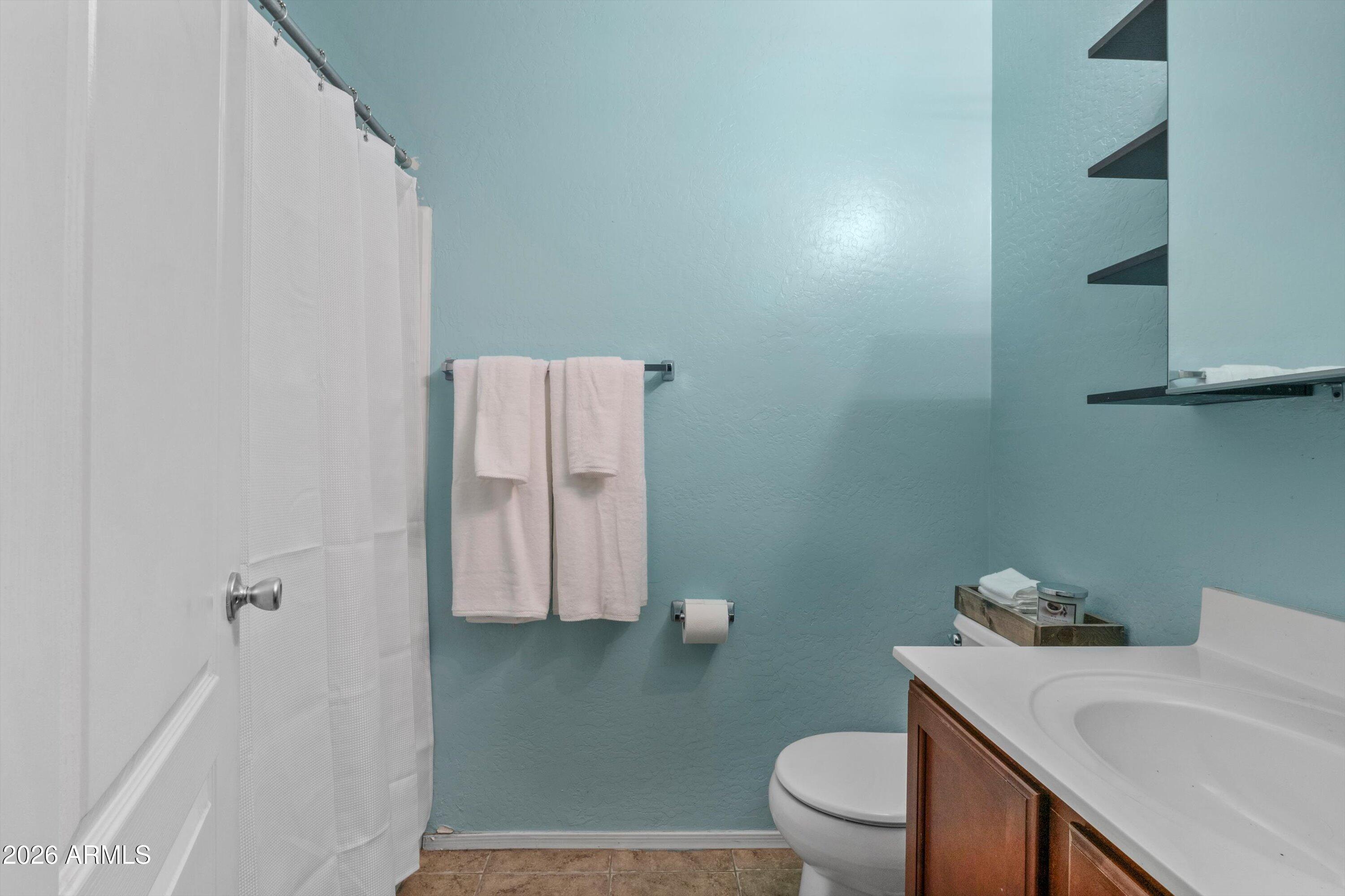 1250 South Rialto, Unit 11 Mesa, AZ 85209 - Photo 16 of 21 a bathroom with a sink a toilet and a mirror