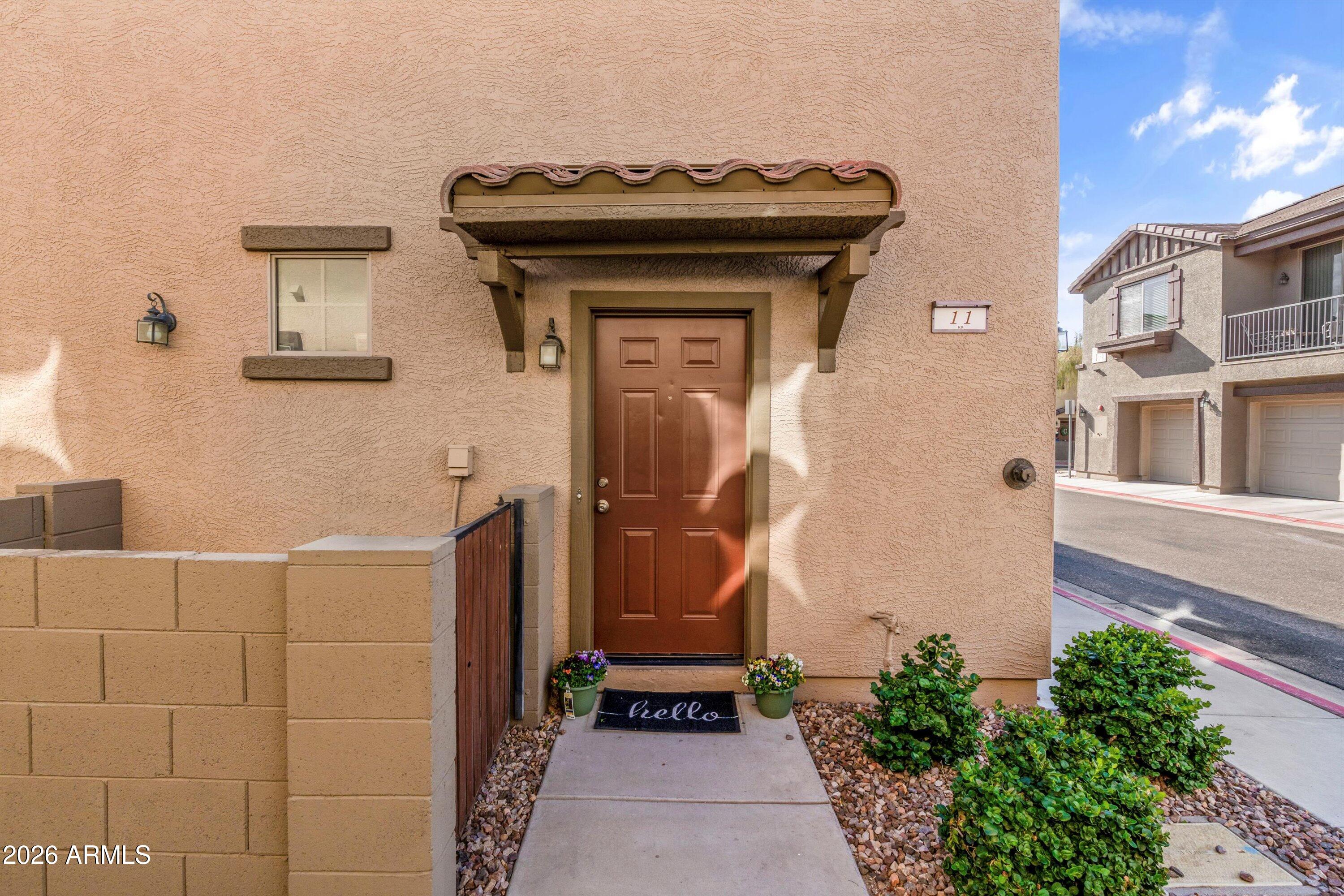 1250 South Rialto, Unit 11 Mesa, AZ 85209 - Photo 2 of 21 a front view of a house with a door
