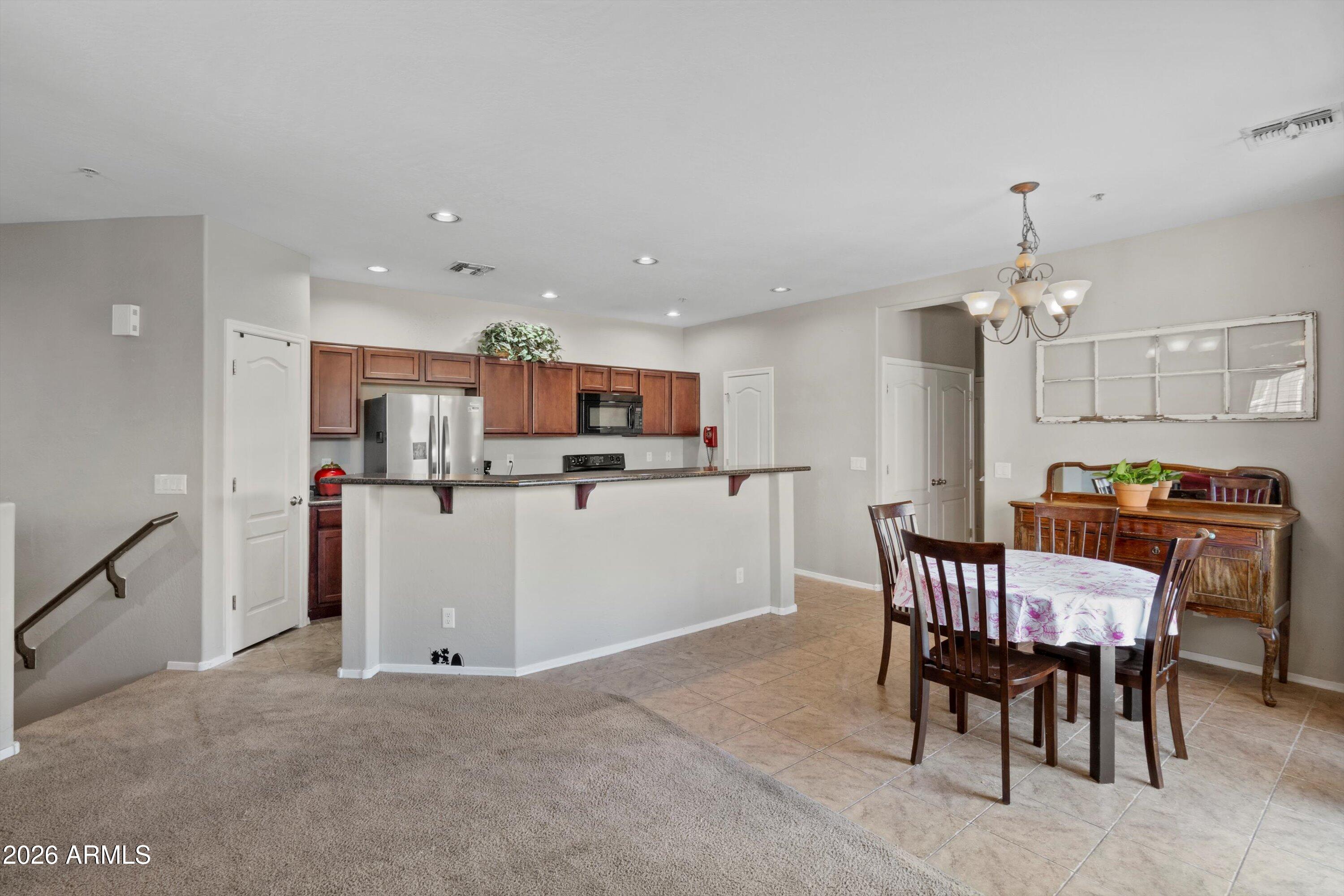 1250 South Rialto, Unit 11 Mesa, AZ 85209 - Photo 3 of 21 a living room with kitchen island furniture and a dining table