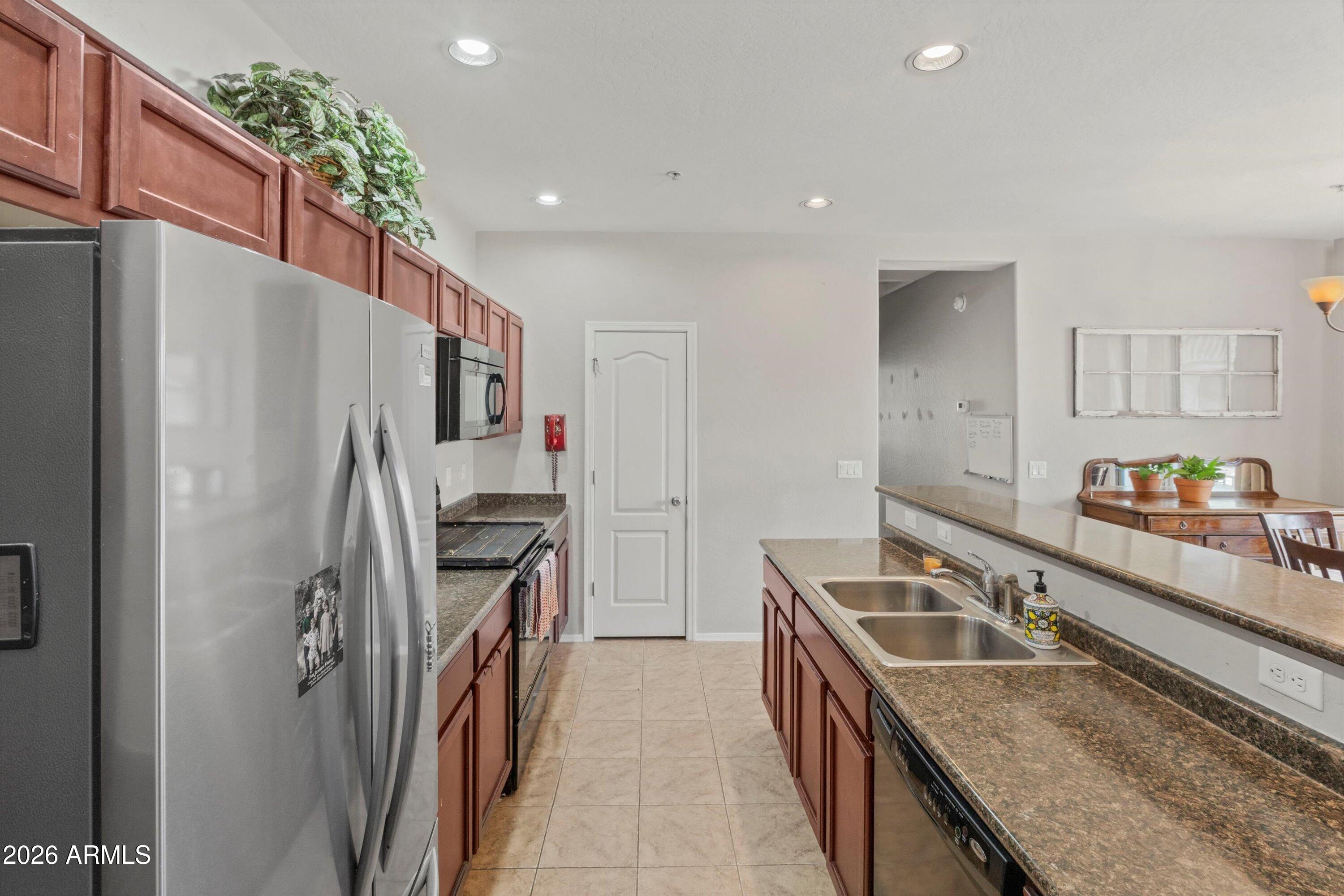 1250 South Rialto, Unit 11 Mesa, AZ 85209 - Photo 5 of 21 a kitchen that has a sink a stove and a refrigerator