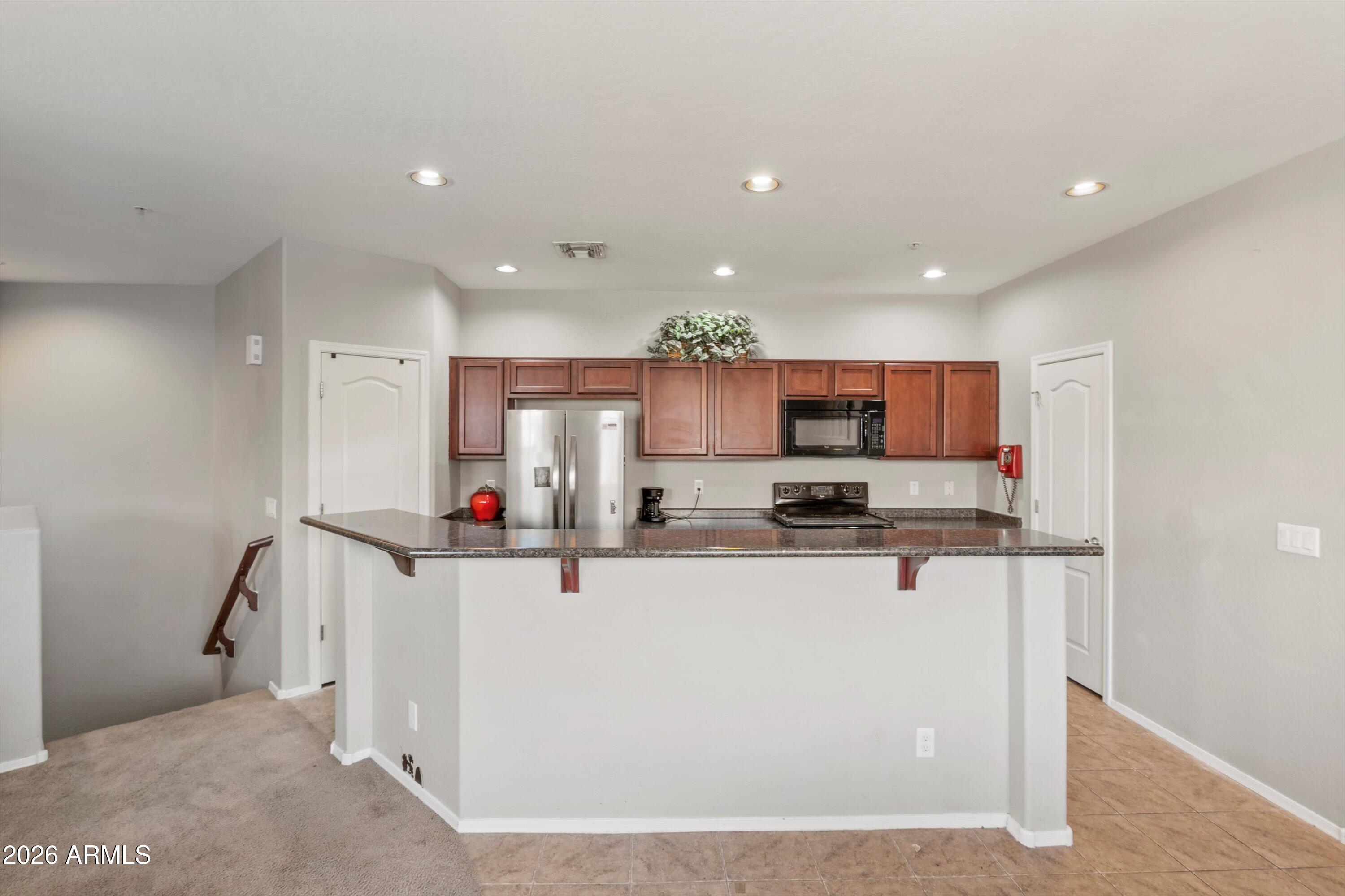1250 South Rialto, Unit 11 Mesa, AZ 85209 - Photo 7 of 21 a view of kitchen and kitchen with stainless steel appliances