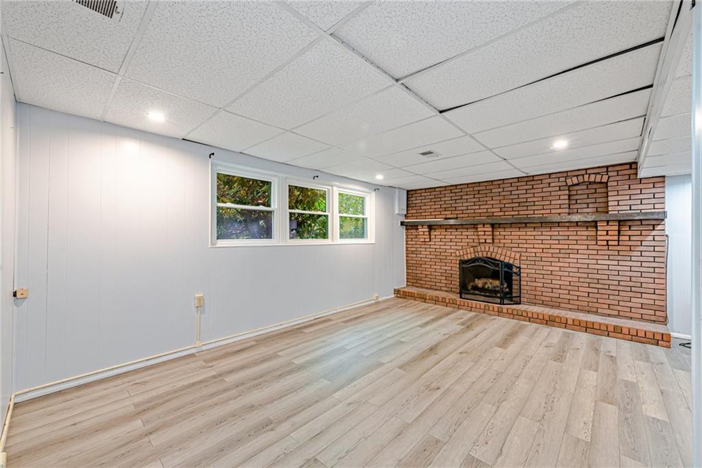 486 Engle Road Industry, PA 15052 - Photo 21 of 38 a view of an empty room with a fireplace and a window