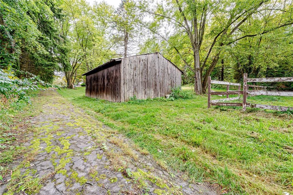 486 Engle Road Industry, PA 15052 - Photo 27 of 38 a view of a backyard with large trees and wooden fence