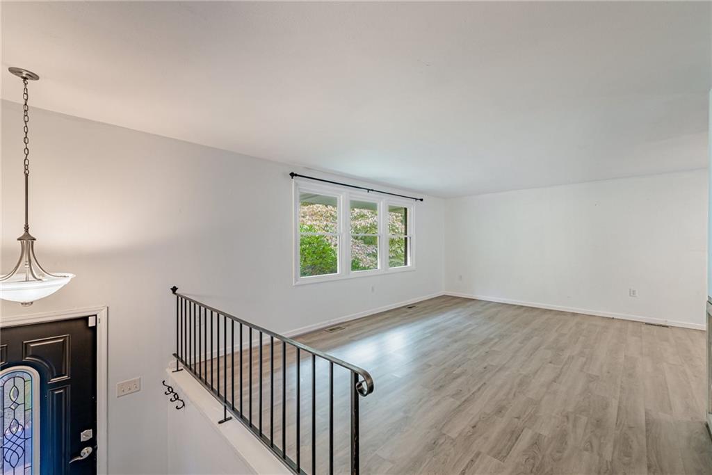 486 Engle Road Industry, PA 15052 - Photo 3 of 38 a view of an empty room with wooden floor and a window