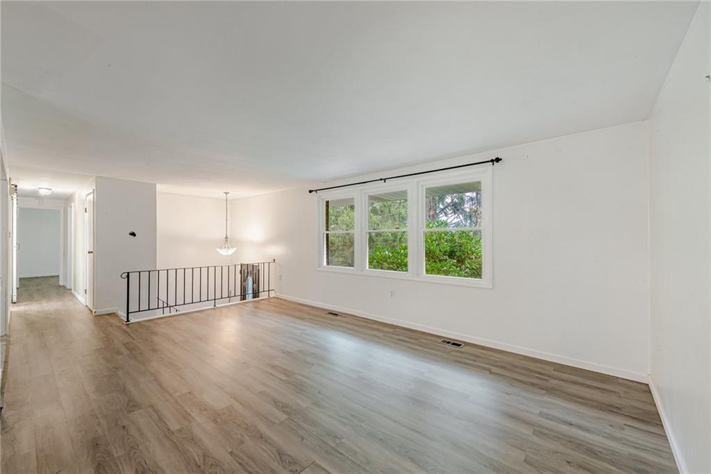 486 Engle Road Industry, PA 15052 - Photo 4 of 38 an empty room with wooden floor and windows