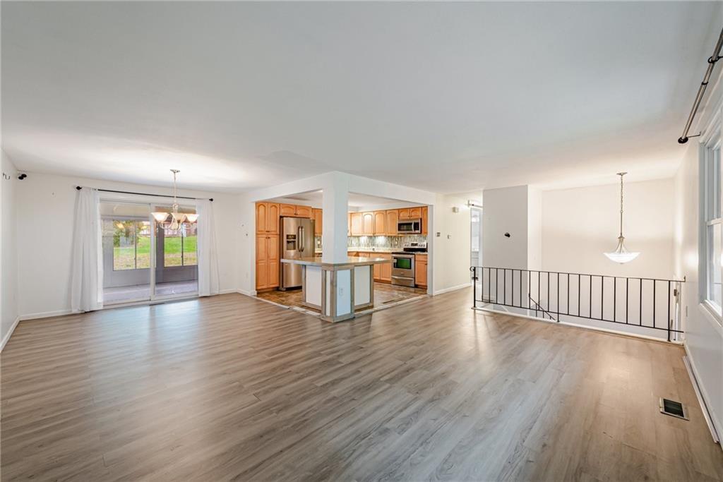 486 Engle Road Industry, PA 15052 - Photo 5 of 38 a view of a big room with wooden floor and windows