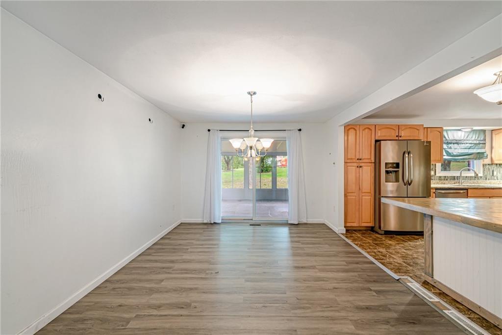 486 Engle Road Industry, PA 15052 - Photo 6 of 38 an empty room with wooden floor and windows