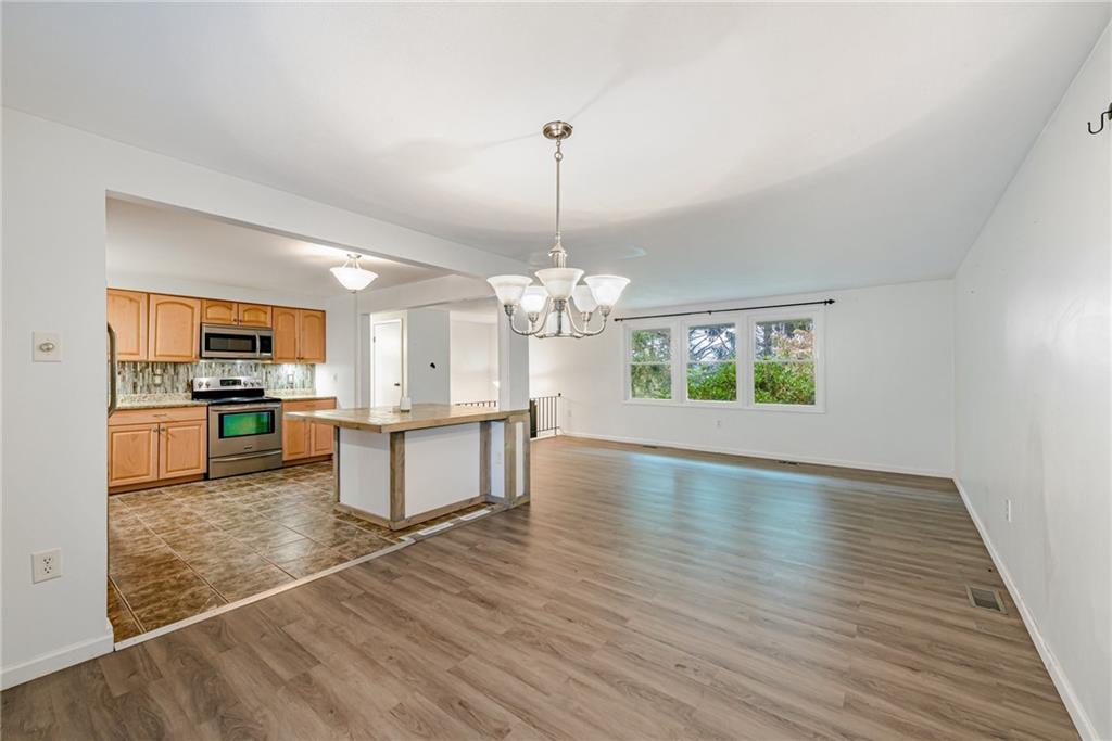486 Engle Road Industry, PA 15052 - Photo 8 of 38 a kitchen with kitchen island a counter top space a sink stainless steel appliances and cabinets