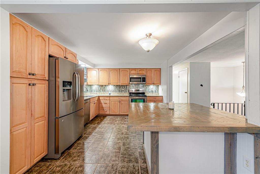 486 Engle Road Industry, PA 15052 - Photo 9 of 38 a kitchen with stainless steel appliances granite countertop a refrigerator a stove and a sink