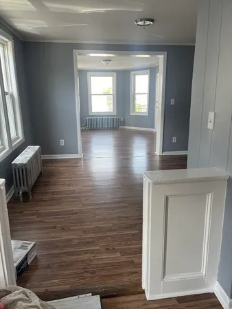 a view of livingroom with hardwood floor and front door