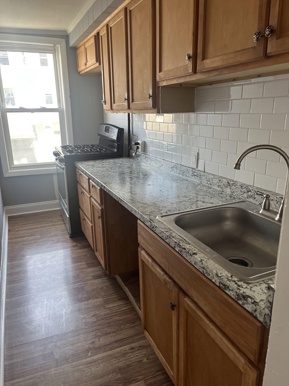 246 Eagle Street, Unit 1W Fall River, MA 02721 - Photo 4 of 8 a kitchen with stainless steel appliances granite countertop a sink stove and cabinets