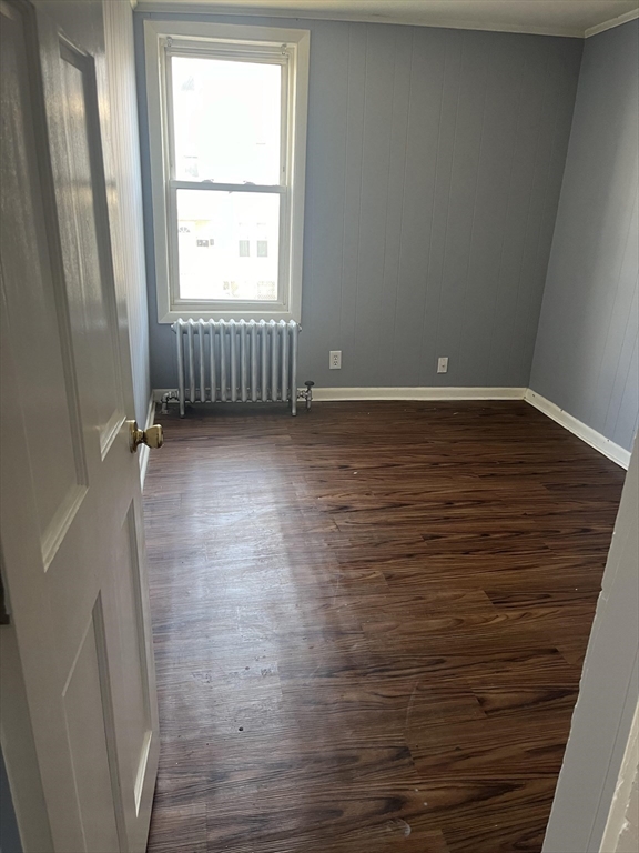 246 Eagle Street, Unit 1W Fall River, MA 02721 - Photo 6 of 8 an empty room with wooden floor and windows