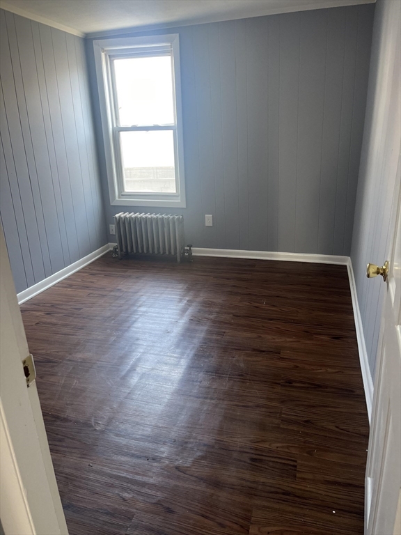 246 Eagle Street, Unit 1W Fall River, MA 02721 - Photo 7 of 8 an empty room with wooden floor and windows