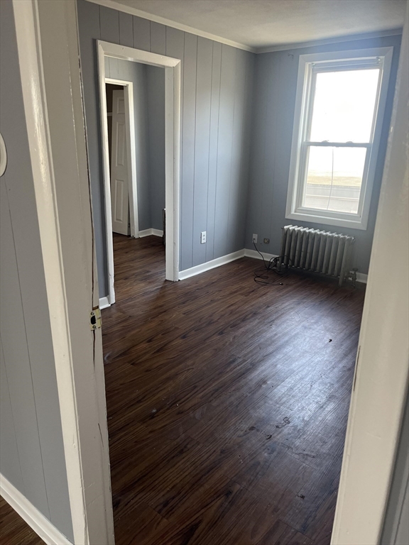 246 Eagle Street, Unit 1W Fall River, MA 02721 - Photo 8 of 8 an empty room with wooden floor and windows