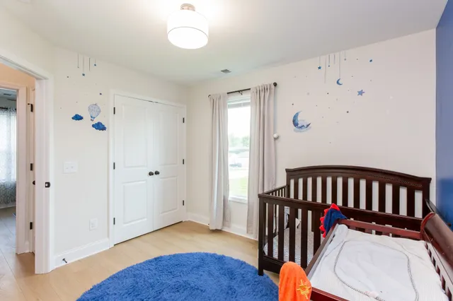 a bedroom with furniture and a window