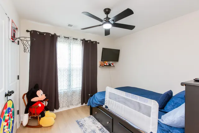 a bedroom with furniture and a window