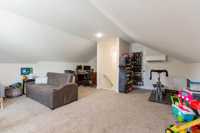 a living room with furniture and a gym equipment