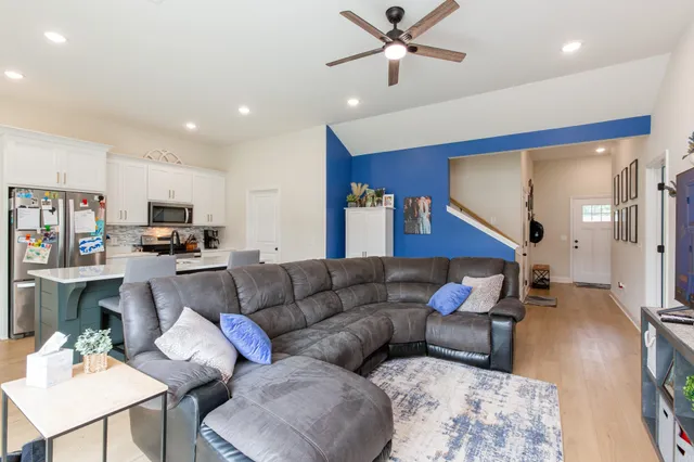 a living room with furniture and kitchen view