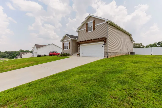 a view of a house with a yard and garage