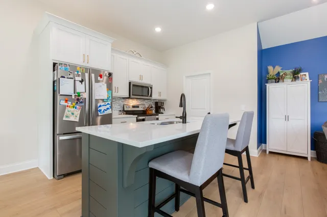 a kitchen that has a table and chairs in it
