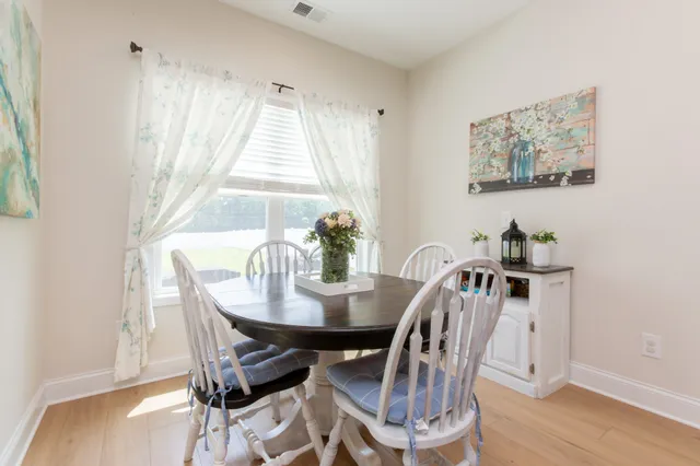a view of a dining room with furniture window and wooden floor
