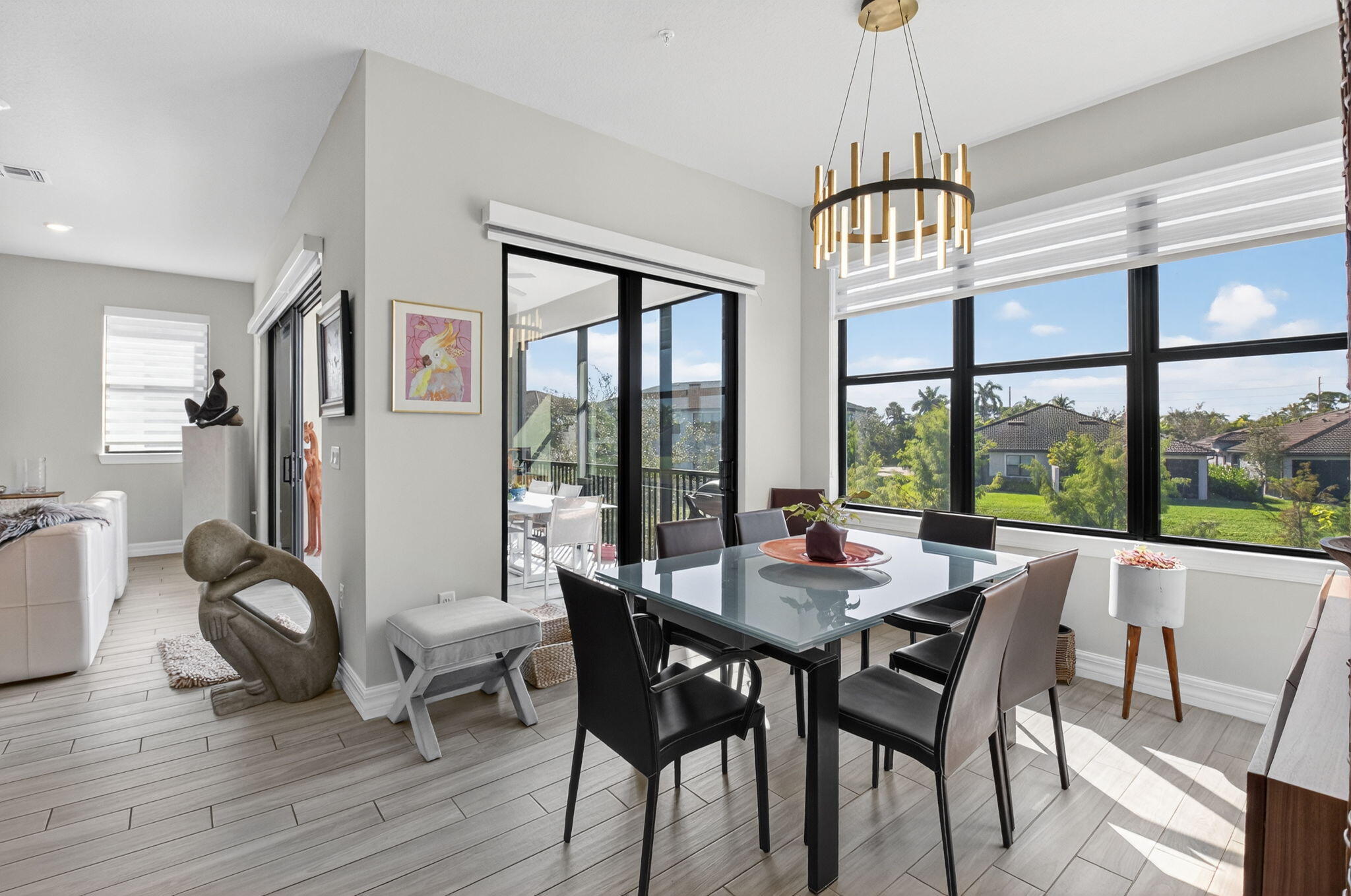 21956 Canadensis Circle, Unit 201 Boca Raton, FL 33428 - Photo 14 of 47 a view of a dining room with furniture window and wooden floor