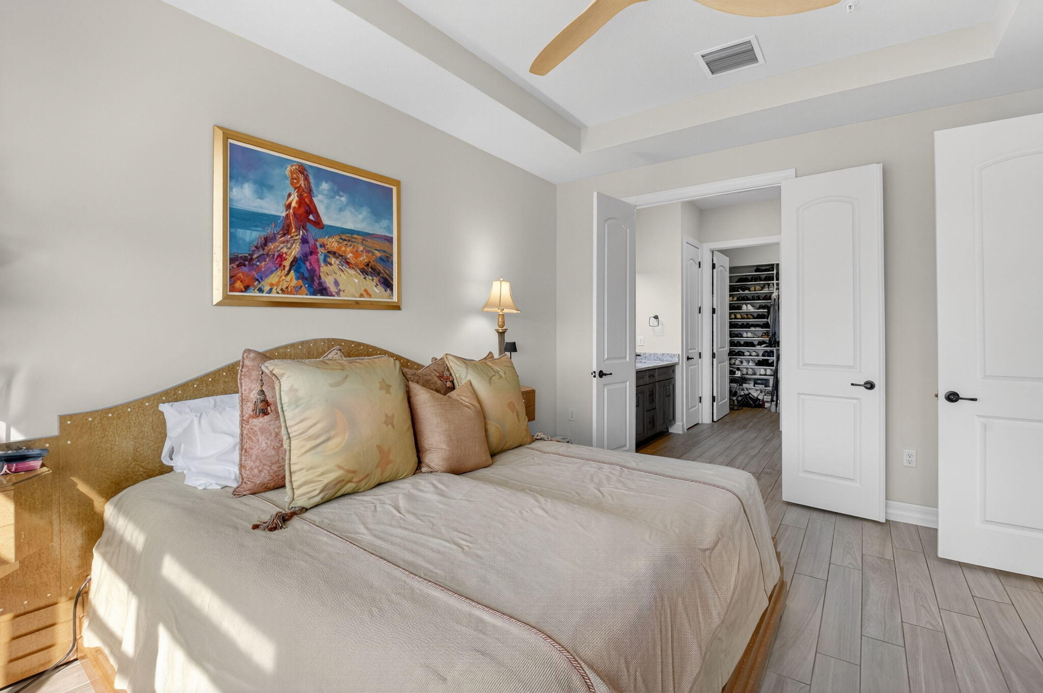 21956 Canadensis Circle, Unit 201 Boca Raton, FL 33428 - Photo 29 of 47 a bedroom with bed and wooden floor