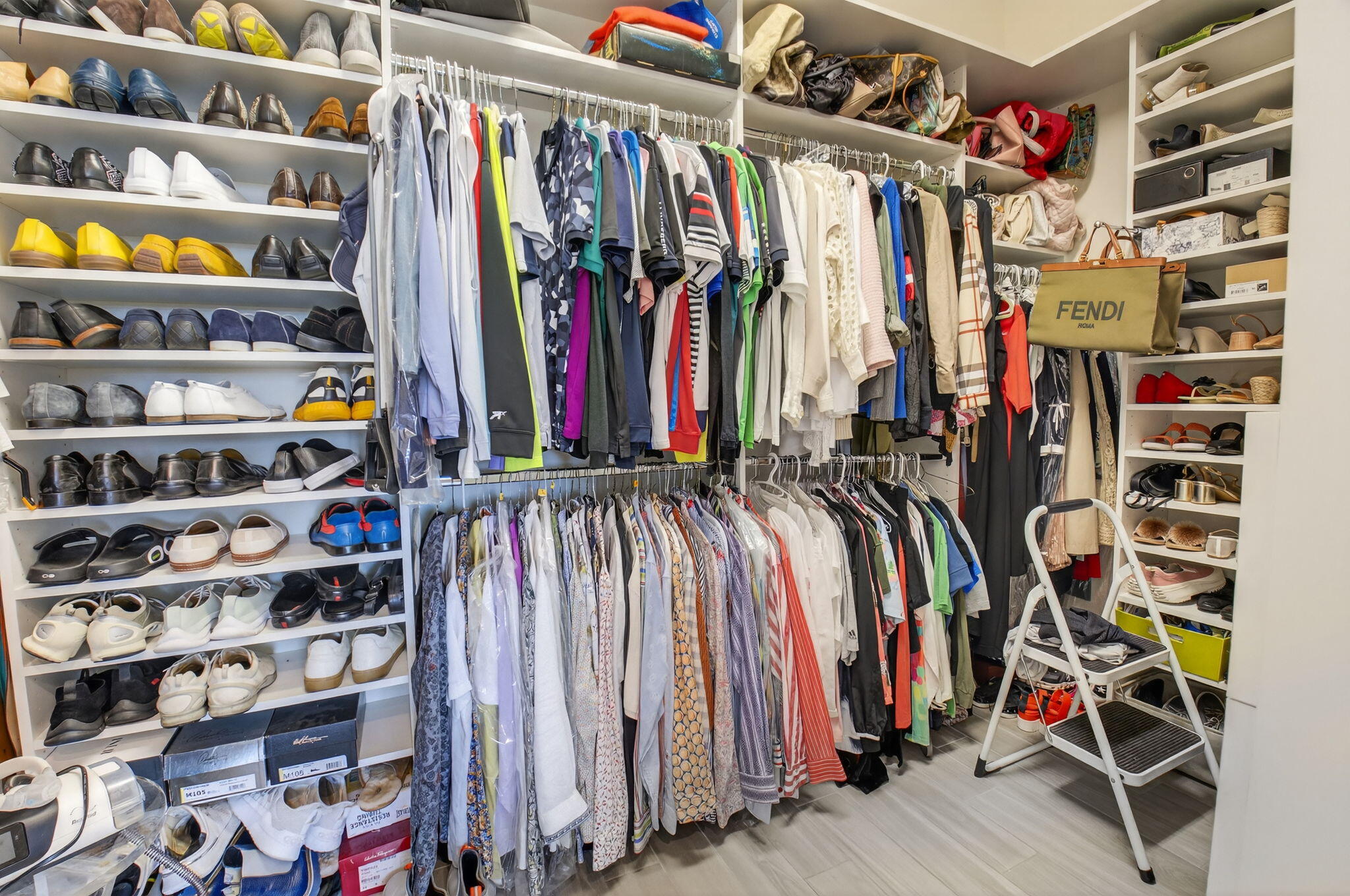 21956 Canadensis Circle, Unit 201 Boca Raton, FL 33428 - Photo 32 of 47 a view of walk in closet with clothes and shoes