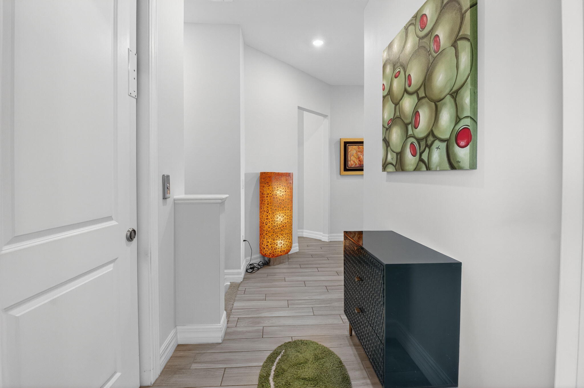 21956 Canadensis Circle, Unit 201 Boca Raton, FL 33428 - Photo 38 of 47 a hallway with painting of the house