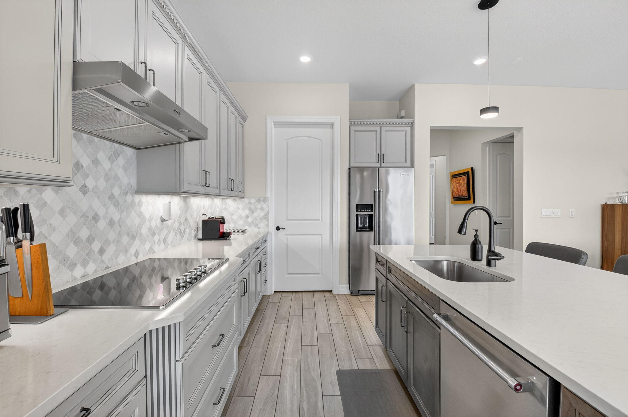 21956 Canadensis Circle, Unit 201 Boca Raton, FL 33428 - Photo 4 of 47 a kitchen with kitchen island granite countertop a sink stainless steel appliances and cabinets