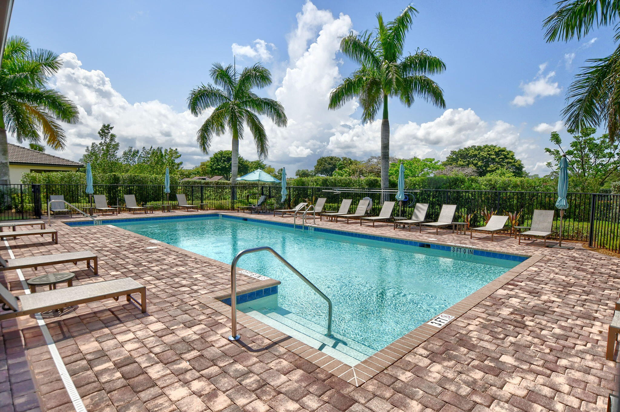 21956 Canadensis Circle, Unit 201 Boca Raton, FL 33428 - Photo 45 of 47 a view of swimming pool with chairs