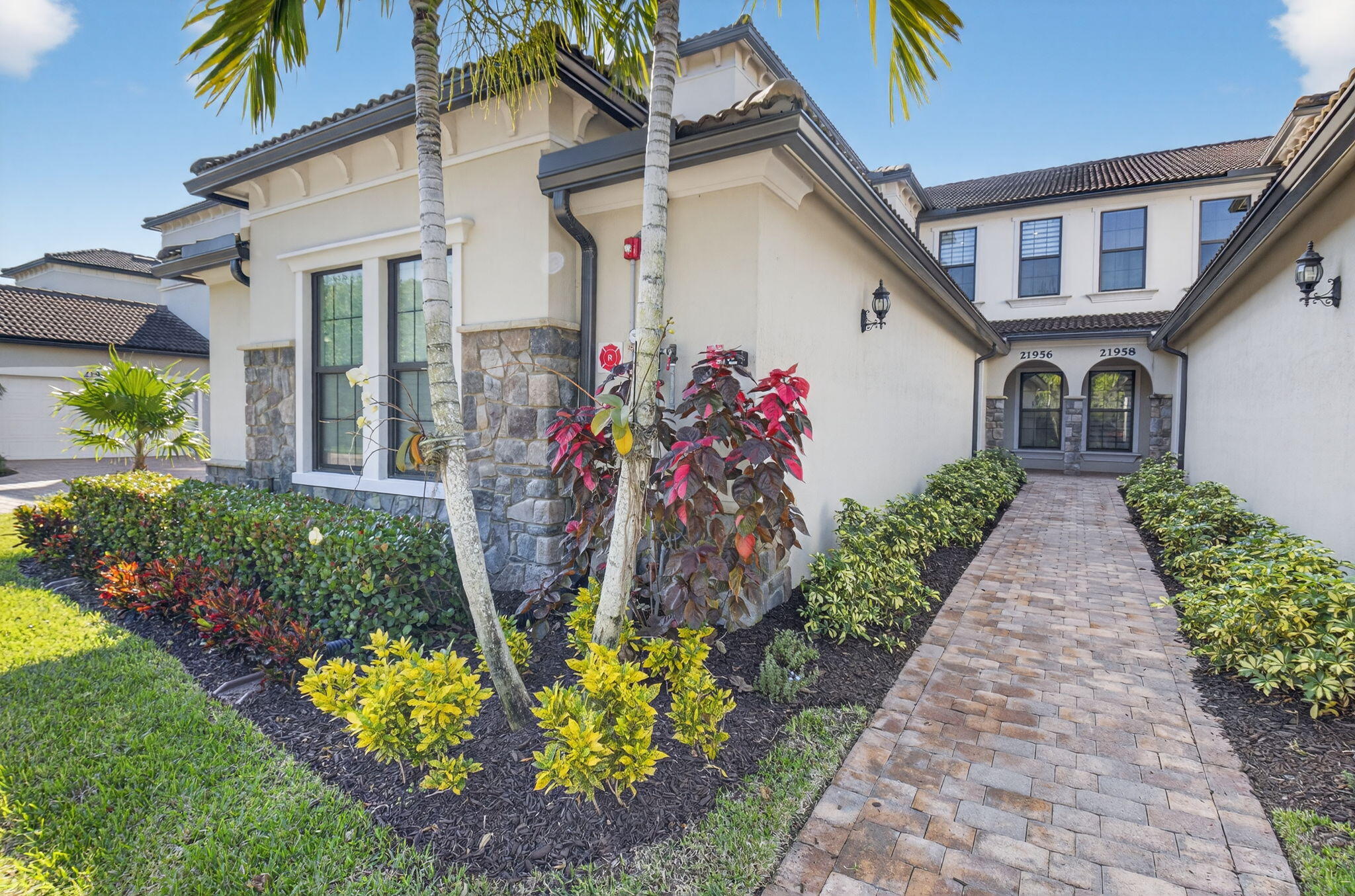 21956 Canadensis Circle, Unit 201 Boca Raton, FL 33428 - Photo 46 of 47 a front view of a house with a yard