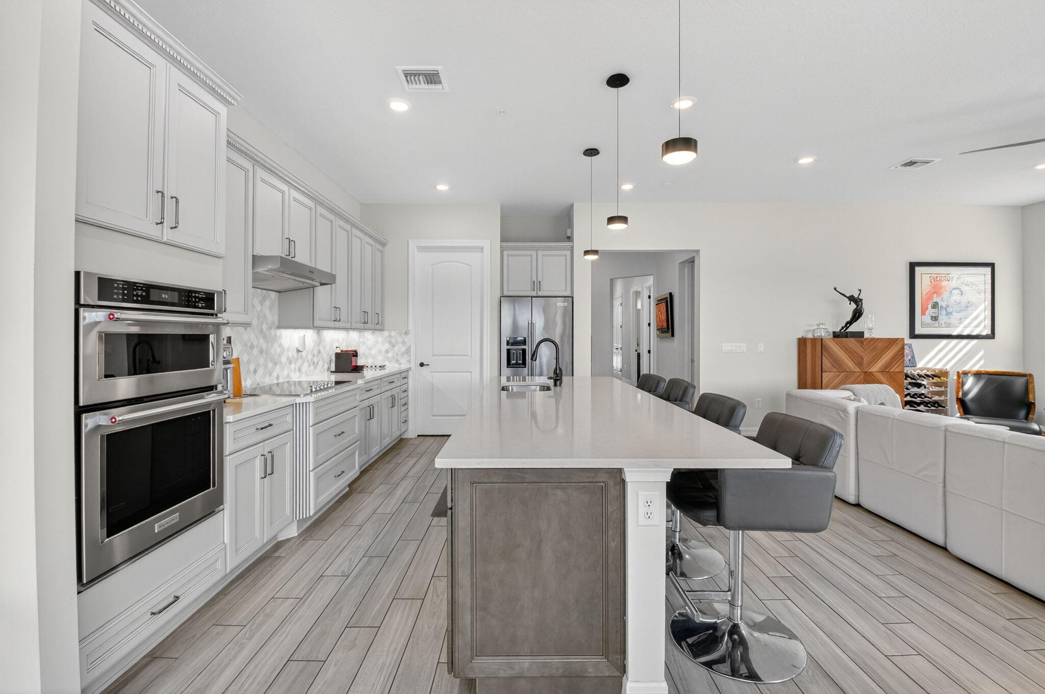 21956 Canadensis Circle, Unit 201 Boca Raton, FL 33428 - Photo 6 of 47 a large kitchen with stainless steel appliances and white cabinets